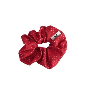 Red polka dot scrunchie with white pattern and decorative bow label for women