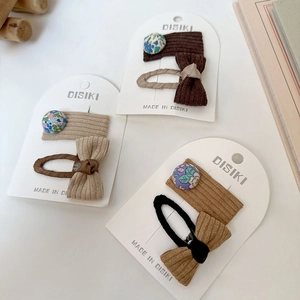 Détails de barrettes en velours côtelé à fleurs et nœuds sur carte de présentation