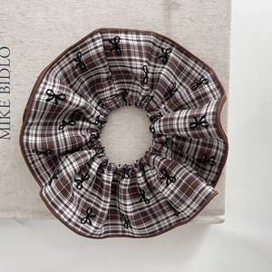 Plaid scrunchie hair tie with black bow embroidery for casual academy style accessory