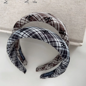 Detailed view of handmade plaid headbands with bow patterns and premium fabric texture