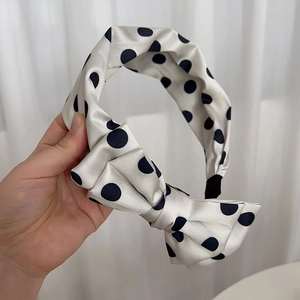 Polka dot bow headband for women made of elegant satin fabric with chic vintage style