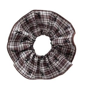 Plaid scrunchie with black bow pattern in brown and white checkered cotton fabric