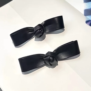 Pair of stylish 3D leather rose hair clips in black with a matte finish for women