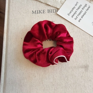 Elegant red velvet scrunchie with white contrast piping for hair accessories