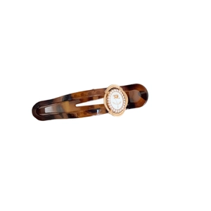 Retro tortoise shell hair clip with gold rose pearl oval charm on a white background