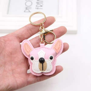 Close-up of pink leather French Bulldog keychain with gold metal ring and lobster clasp