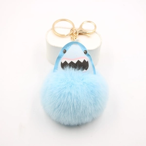 Light blue shark pom-pom keychain with leather shark charm and golden metal ring
