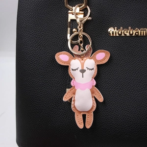 Cute PU leather reindeer keychain bag charm with gold metal clasp on black leather bag
