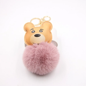 Cute cartoon bear plush keychain with a soft pink pom-pom and golden metal ring