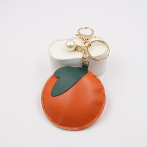 Vibrant persimmon fruit leather keychain with gold hardware and pearl bead charm