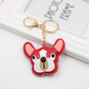 Detail of red and pink PU leather French bulldog keychain with golden lobster clasp