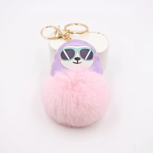 Sloth cartoon faux fur pompom keychain with purple leather detail and golden metal ring