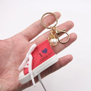 Portachiavi mini sneaker in tela rossa con stampa a cuore e ciondolo perla