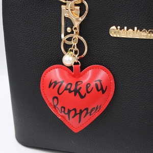Red heart faux leather keychain with make it happen print and pearl charm detail