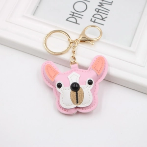 Detail of pink PU leather French Bulldog keychain with golden hook on a white frame