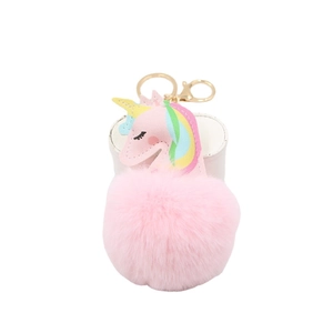 Pink unicorn pompom keychain with golden metal ring and soft plush fur ball accessory