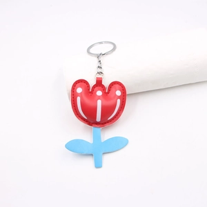 Tulip leather keychain accessory with red spotted flower and blue stem on white background