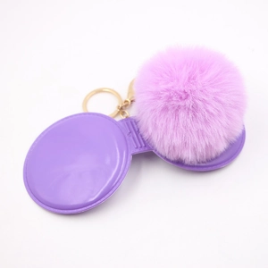 Detailed view of lavender faux fur pompom keychain with golden metal clasp for bags
