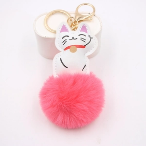Detail of cartoon lucky cat leather keychain with a fluffy bright pink faux fur pompom