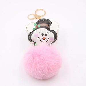Detail view of pink pompom keychain with snowman charm and golden lobster clasp