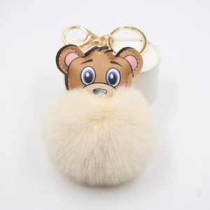 Porte-clés ours en similicuir avec gros pompon en fausse fourrure crème et fermoir doré