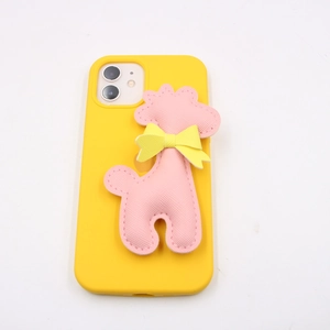 Yellow silicone phone case with pink plush giraffe doll and yellow bow decoration