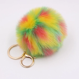 Close-up of fluffy rainbow faux fur keychain with gold-plated metal clasp and ring