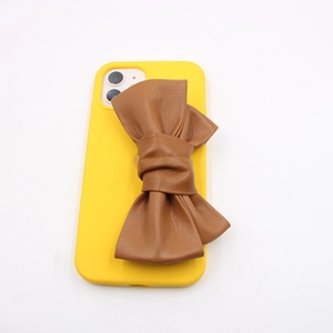 Lemon yellow iPhone case featuring a large 3D brown PU leather bow accessory