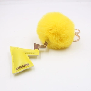 Yellow fluffy pompom keychain with lightning leather charm and golden keyring for bags