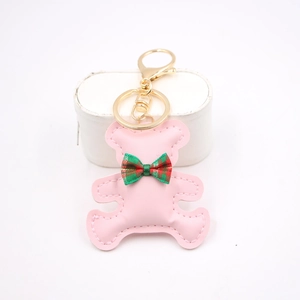 Pink leather bear keychain with red green plaid bowtie and golden metal clasp for bags