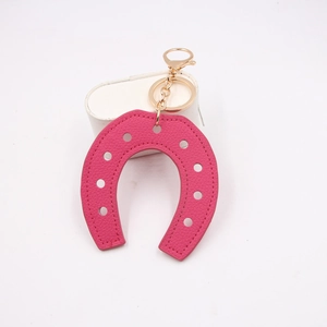 Pink horseshoe PU leather keychain with litchi pattern and gold metal hardware