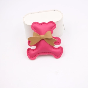 Detail of rose red leather bear pendant with brown bow for DIY phone cases and accessories