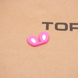 Close-up of pink and white silicone bunny ears accessory for DIY crafts and shoe charms
