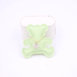 Detail of gold chain necklace with To My Mother engraved pendant on green bear card
