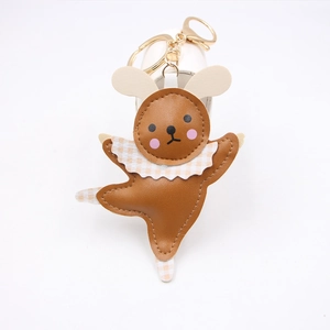 Close-up of brown leather ballet rabbit keychain with golden metal clasp and plaid bow