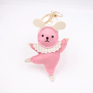 Detail of pink leather dancing bunny keychain with yellow plaid collar and golden clasp