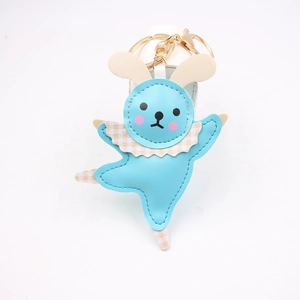 Detail of light blue leather ballet rabbit keychain with plaid collar and gold clasp