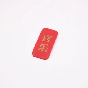 Red textured leather keychain tag with gold embossed Chinese characters Joy and Happiness