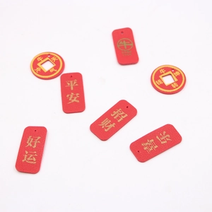 Red leather keychains with gold stamped Chinese characters for luck and peace