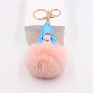 Pink faux fur pompom keychain with blue Christmas tree tag and golden metal lobster clasp