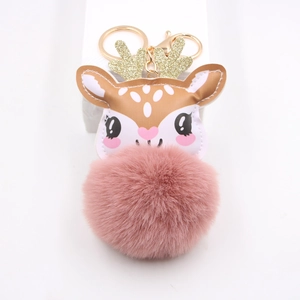 Detailed view of cute reindeer plush keychain with pink pompom and gold lobster clasp