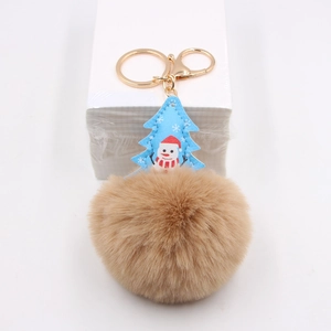 Detail of Christmas tree bag charm with brown pompom and gold lobster clasp