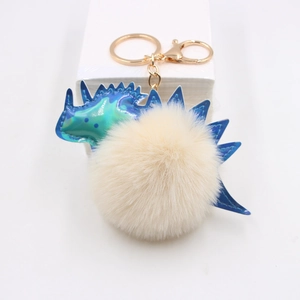 Pendentif dinosaure en cuir laser avec pompon blanc cassé et porte-clés doré chic