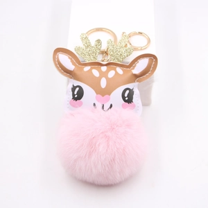 Close-up of pink fluffy plush deer keychain with glittery antlers and golden hardware