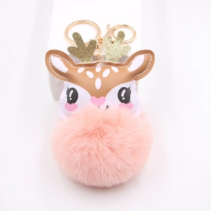 Detail of cute reindeer plush keychain with pink pompom and sparkling golden antlers
