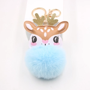 Detail of blue plush reindeer keychain with golden sequins antlers and metal clasp