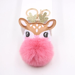 Cute reindeer plush keychain with a pink pompom and golden antlers for Christmas bags