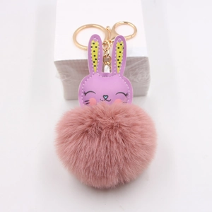 Detail of purple faux leather bunny keychain with a soft pink pompom and gold ring