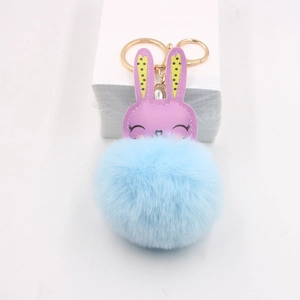 Cute bunny pompom bag charm with purple faux leather head and light blue fur ball
