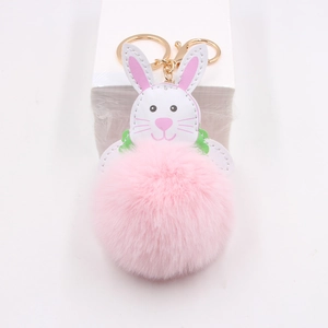 Pink plush bunny pompom keychain with golden metal ring and white leather detail